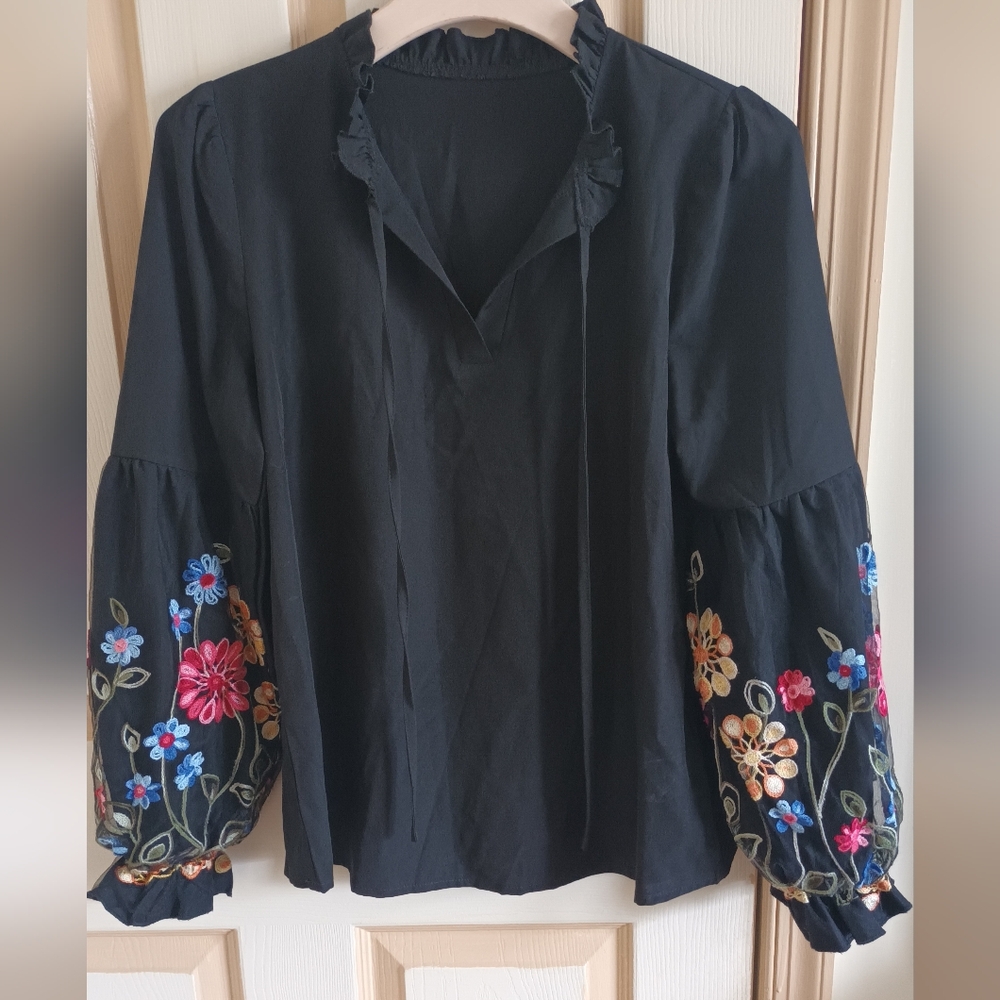 Black Ruffled Blouse with Mandarin Collar and Floral Embellishments
